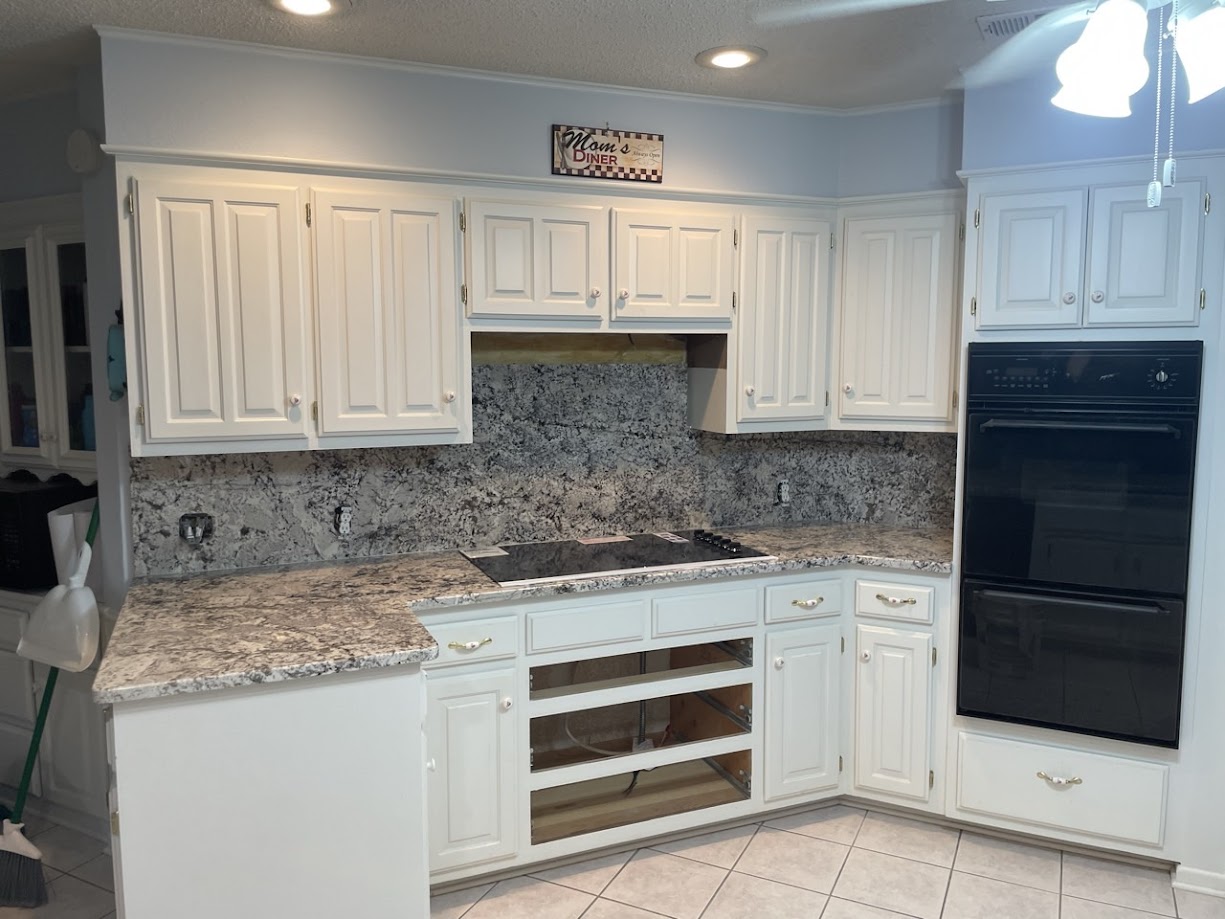 Blue Nile granite kitchen countertops on white cabinets — Central Texas installation