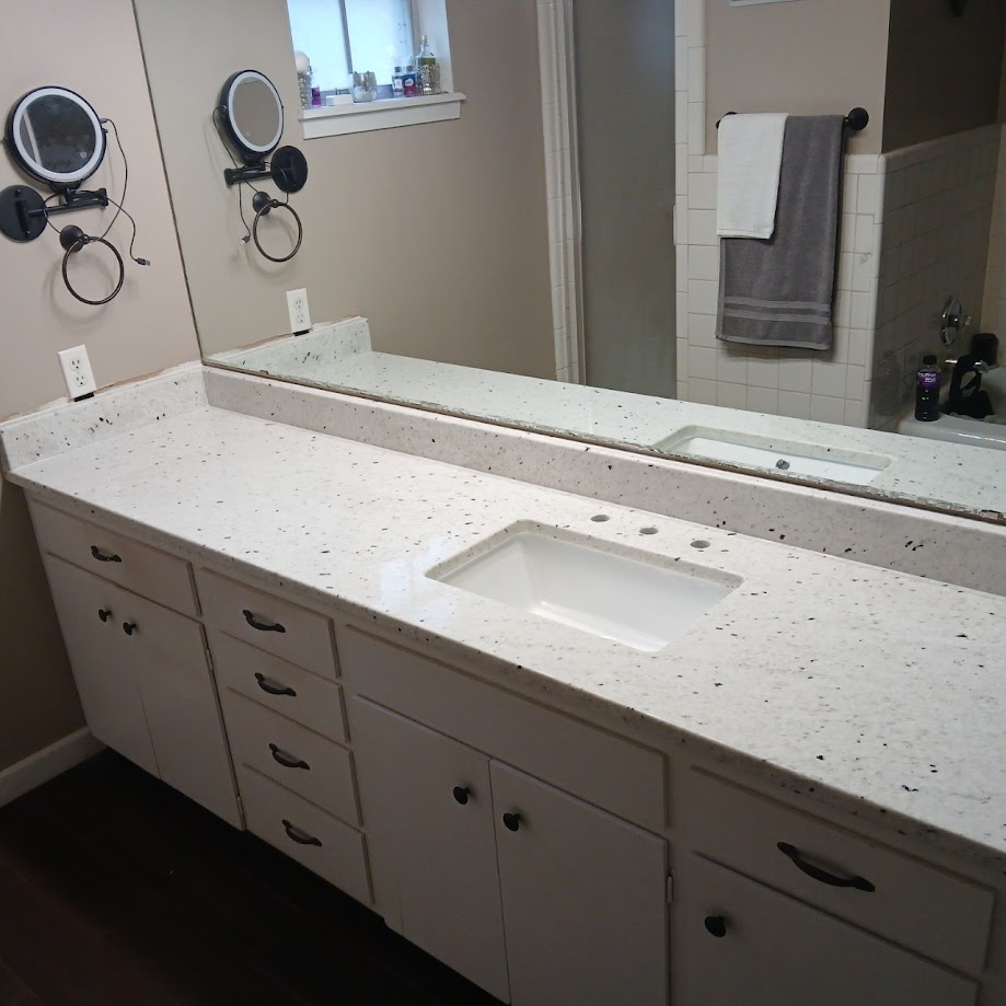 Cotton White granite double vanity bathroom countertop with undermount sinks and white cabinets — Central Texas