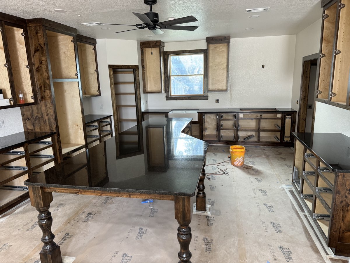 Black polished granite kitchen island new construction — Heart of Texas Granite & Marble
