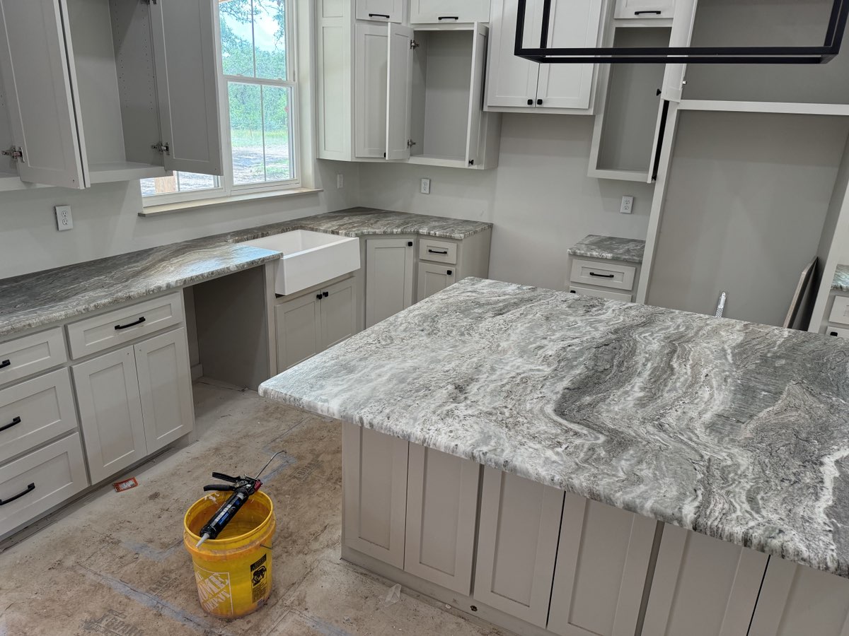 Brown Fantasy marble island and full perimeter countertops with grey shaker cabinets — Central Texas kitchen installation