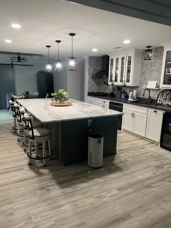 Shadow Storm marble kitchen island with white and grey veining on dark teal base — Heart of Texas Granite & Marble Central Texas