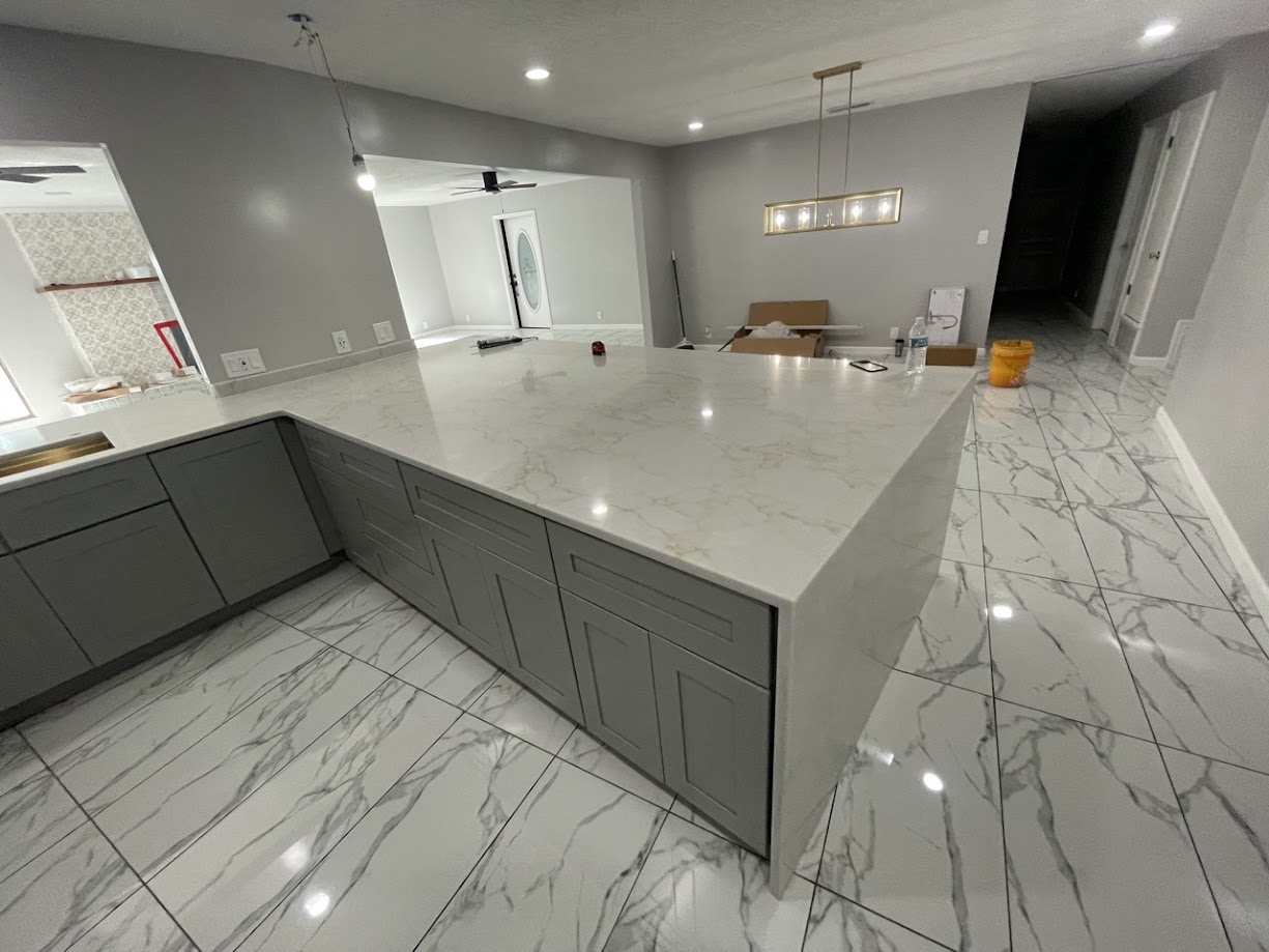 Milan Gold quartz kitchen island with white gold and grey veining on grey shaker cabinets — new construction Central Texas