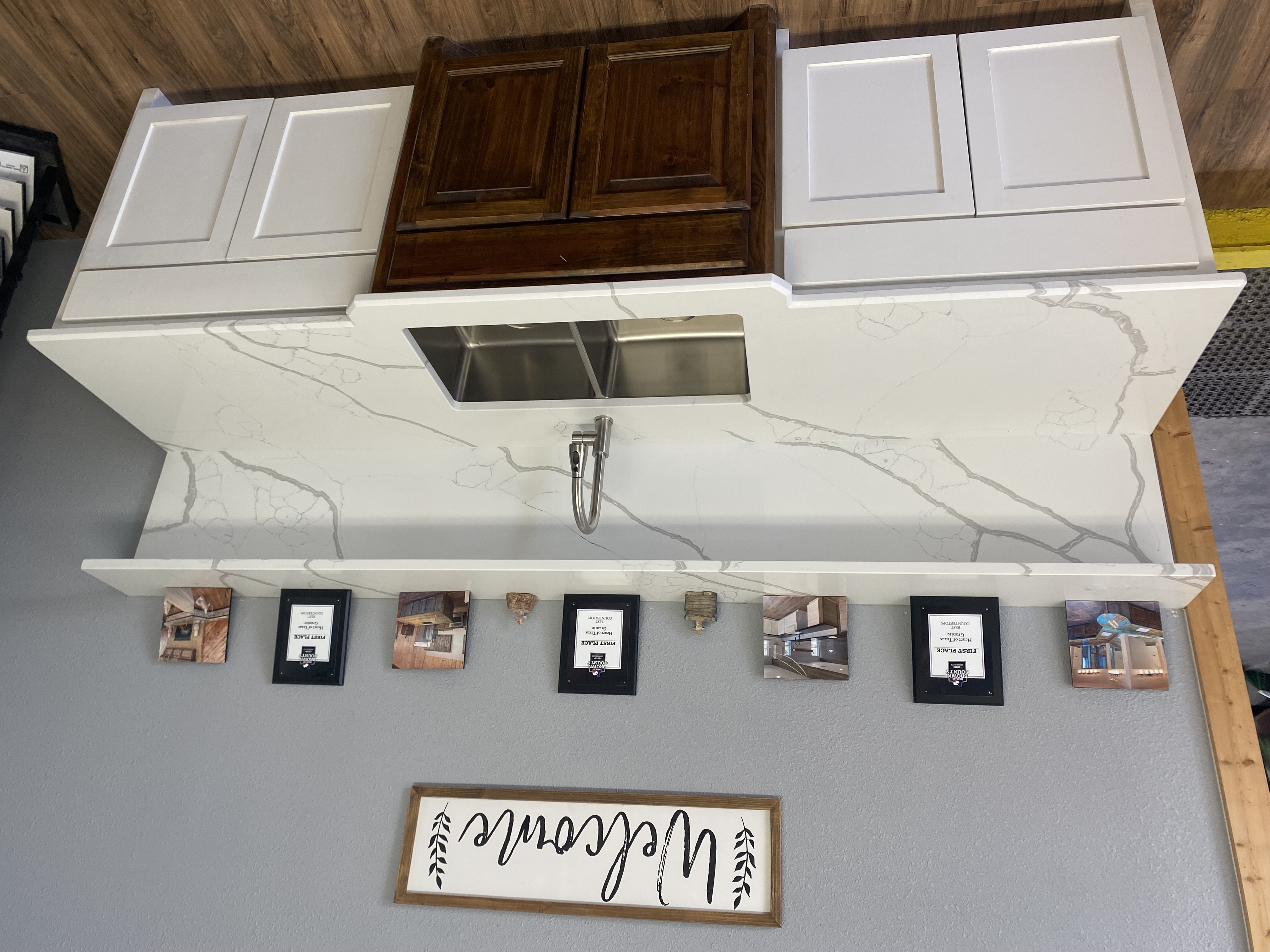 Heart of Texas Granite and Marble showroom display of white quartz countertop with grey veining — award-winning countertop fabrication Brownwood TX