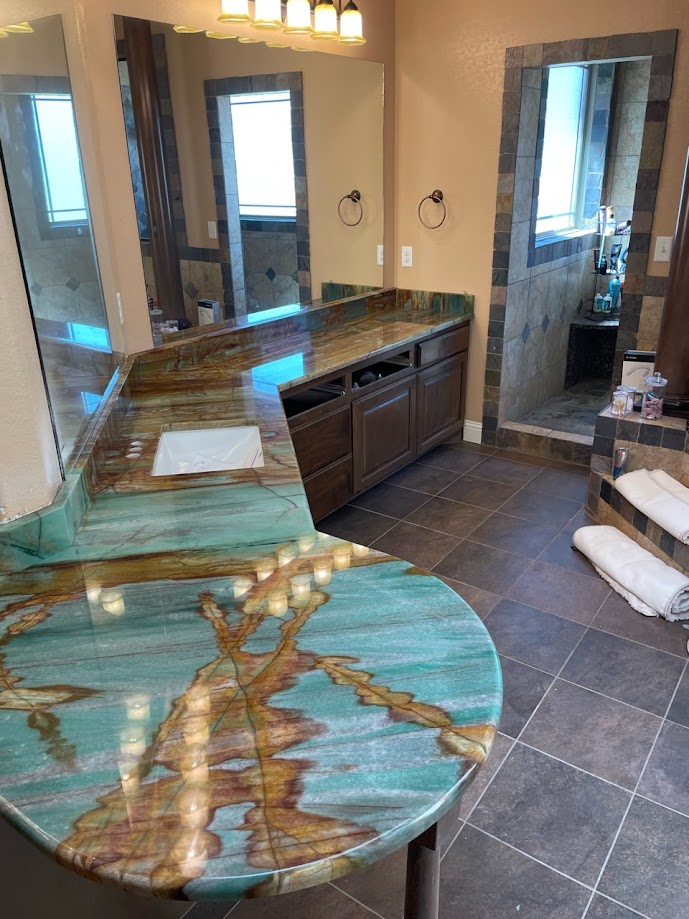 Sauipe quartzite bathroom vanity with teal turquoise and gold veining on curved profile — Central Texas
